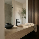 Marble bathroom vanity with matt black basin mixer with round spout.