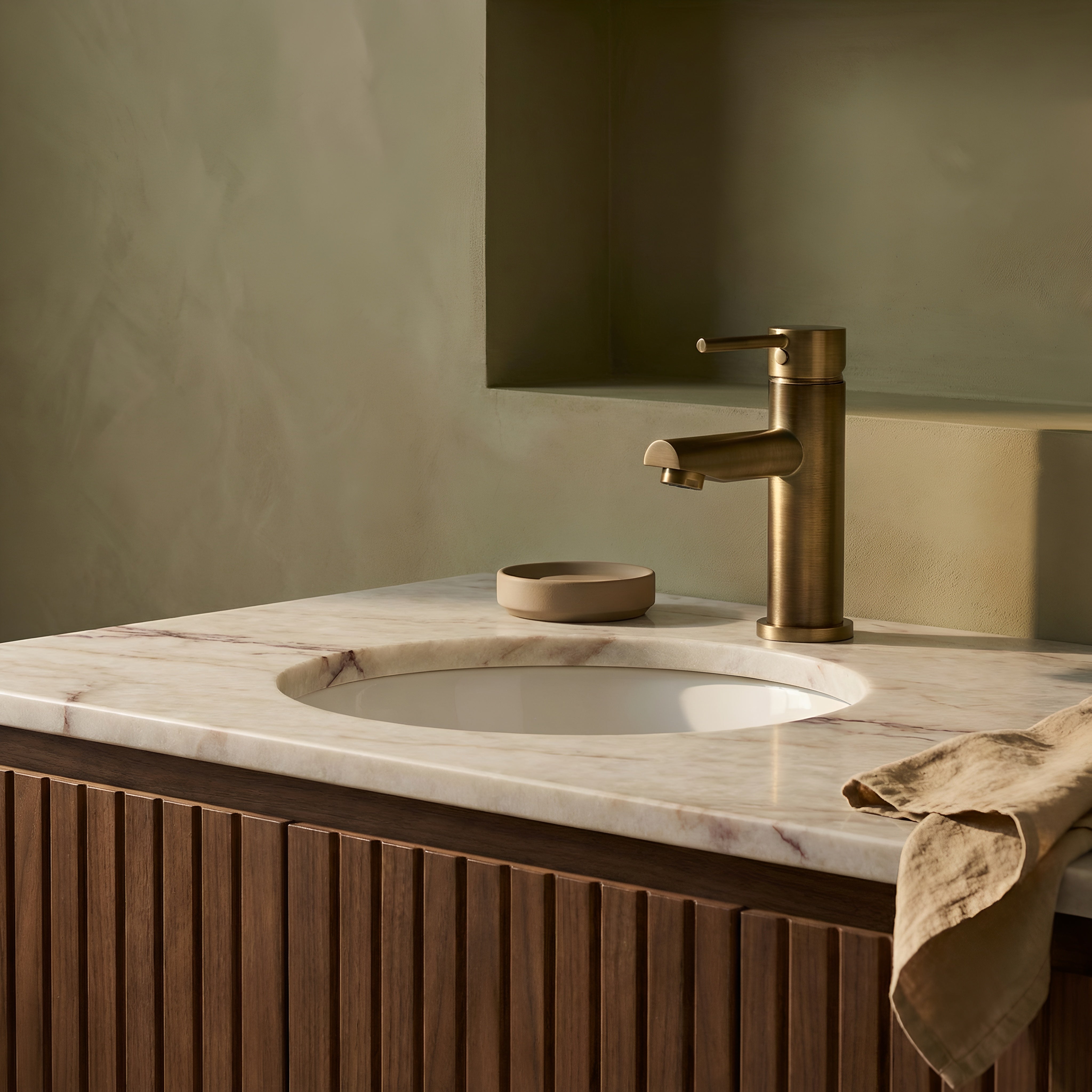 Bathroom vanity with marble countertop, sink, and antique brass basin mixer with round spout