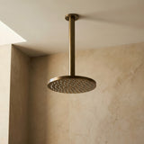 Antique Brass ceiling arm shown with shower head in a bathroom