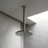 Brushed Nickel shower arm shown with shower head in a neutral shower area