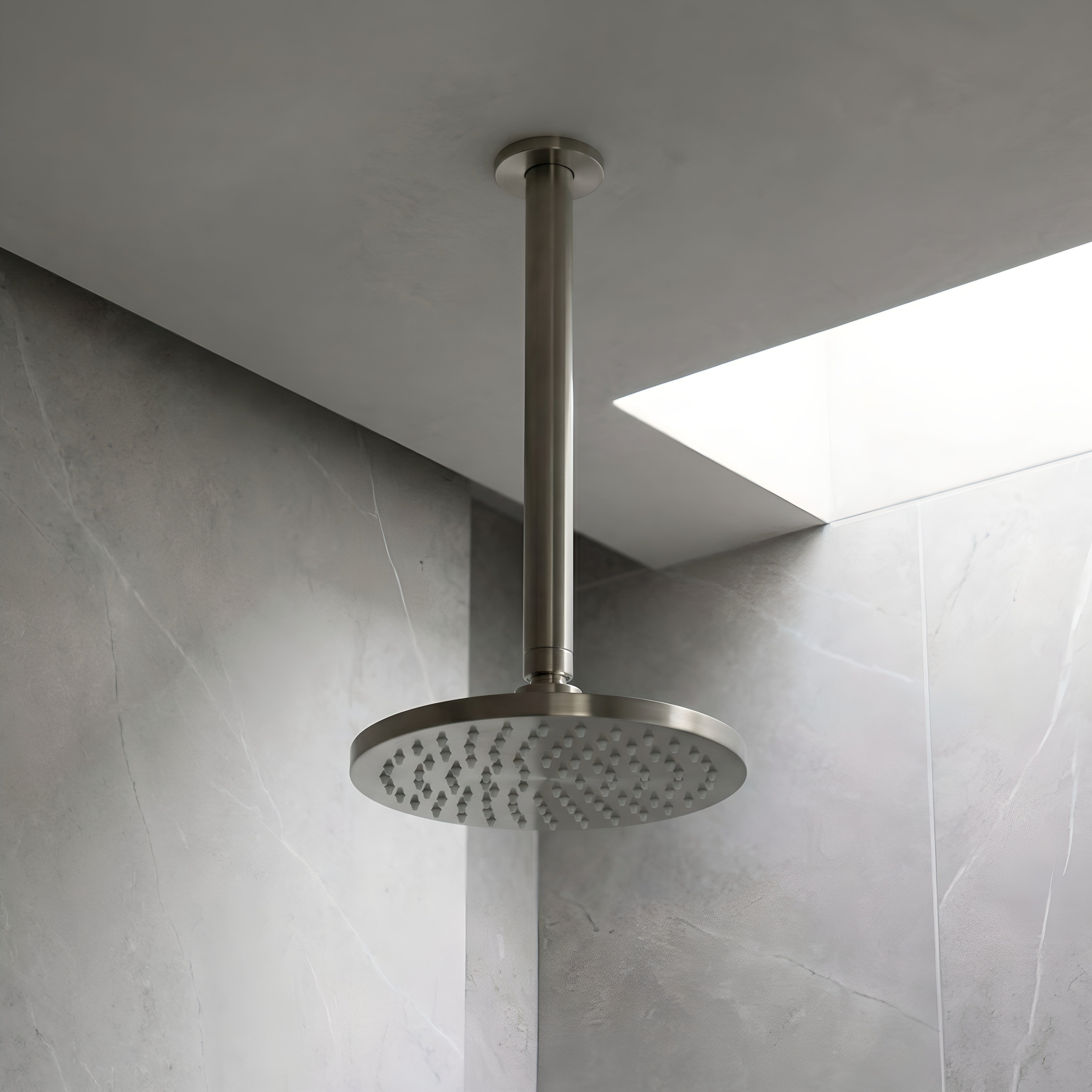 Brushed Nickel shower arm shown with shower head in a neutral shower area