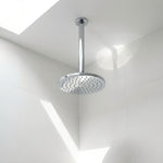 Chrome ceiling arm shown with shower head in a bathroom 
