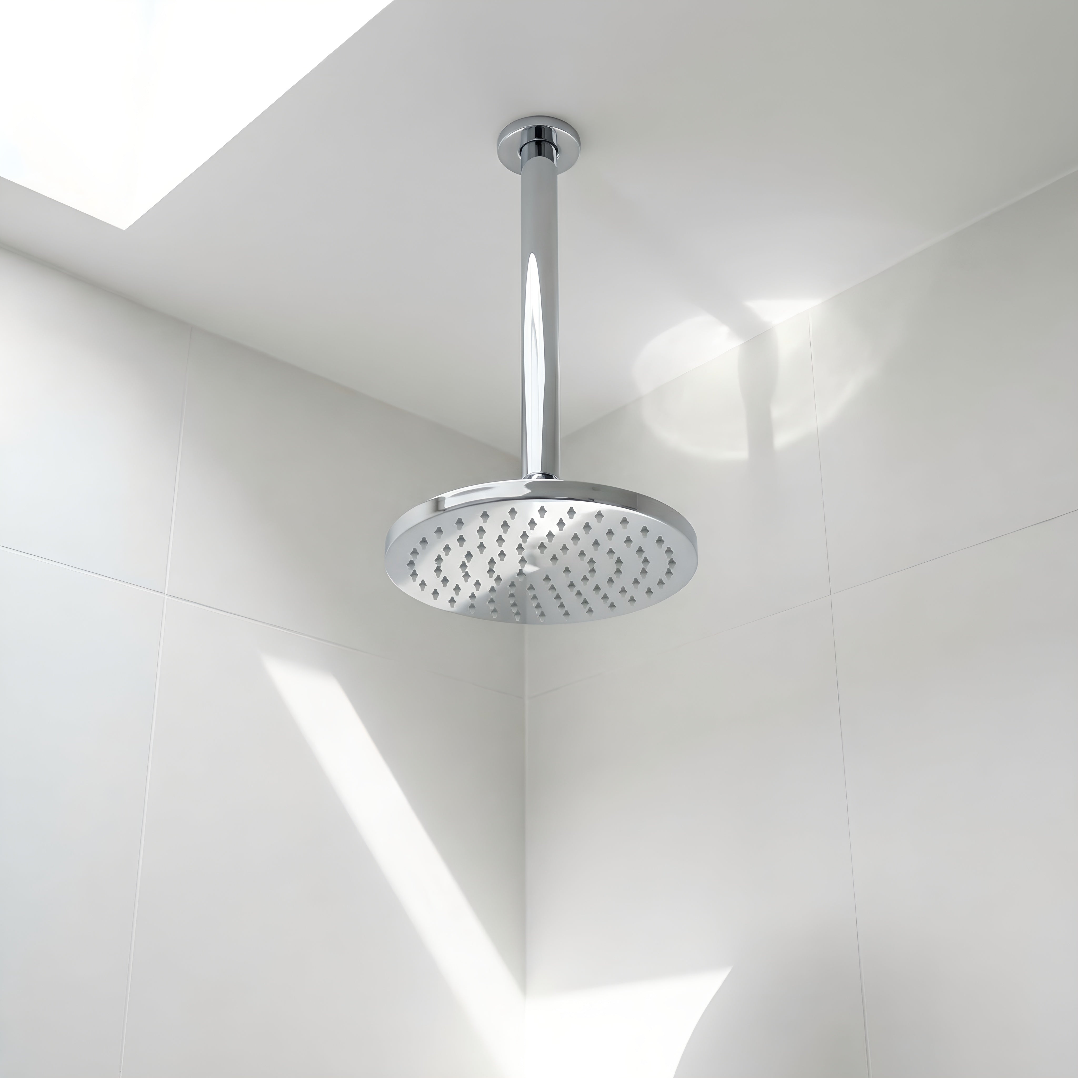 Chrome ceiling arm shown with shower head in a bathroom 