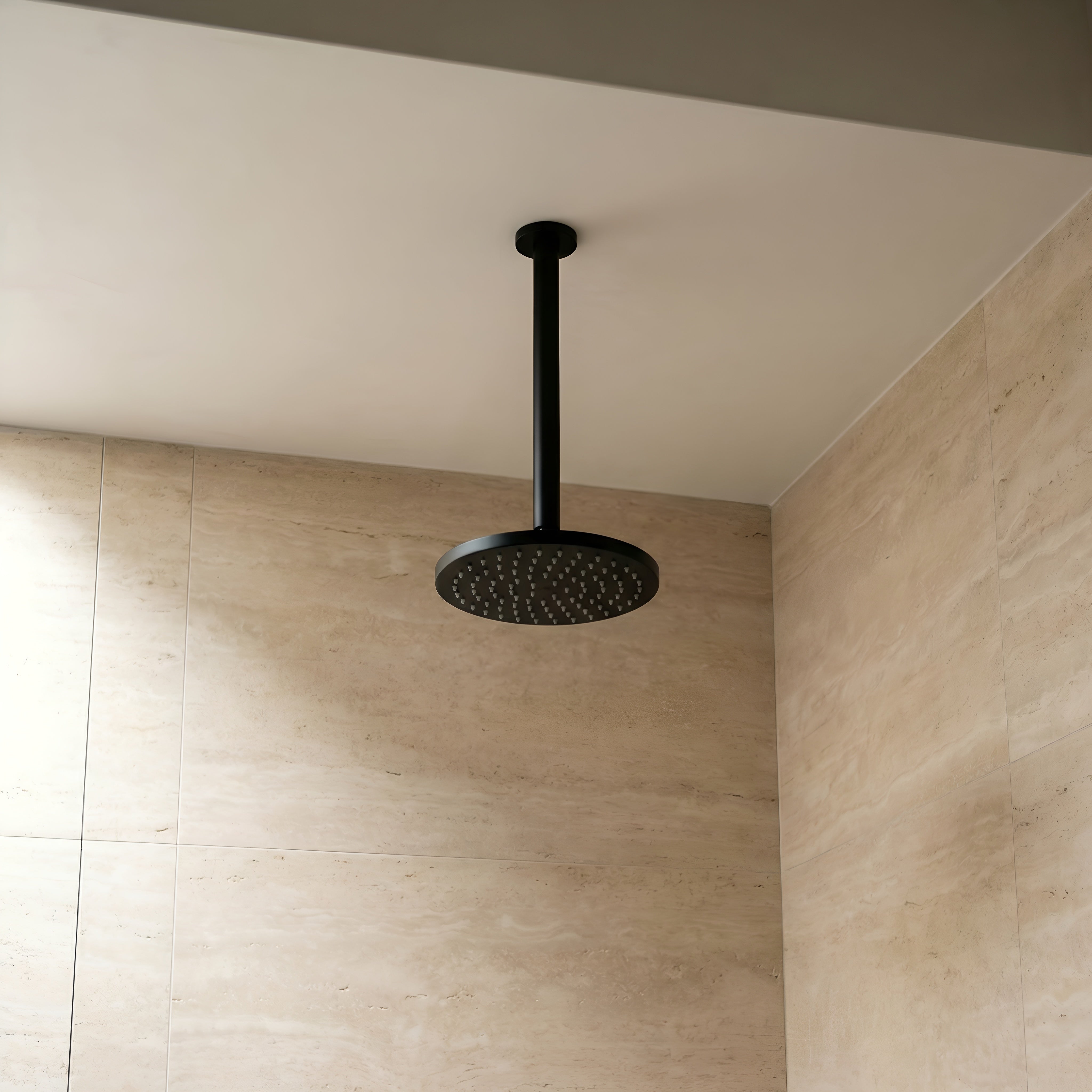 Matt Black ceiling arm shown with showerhead in a bathroom