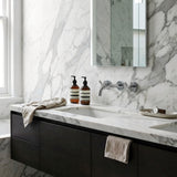 Bathroom vanity with marble countertop, dark cabinets, with Chrome cross handle taps and wall spout