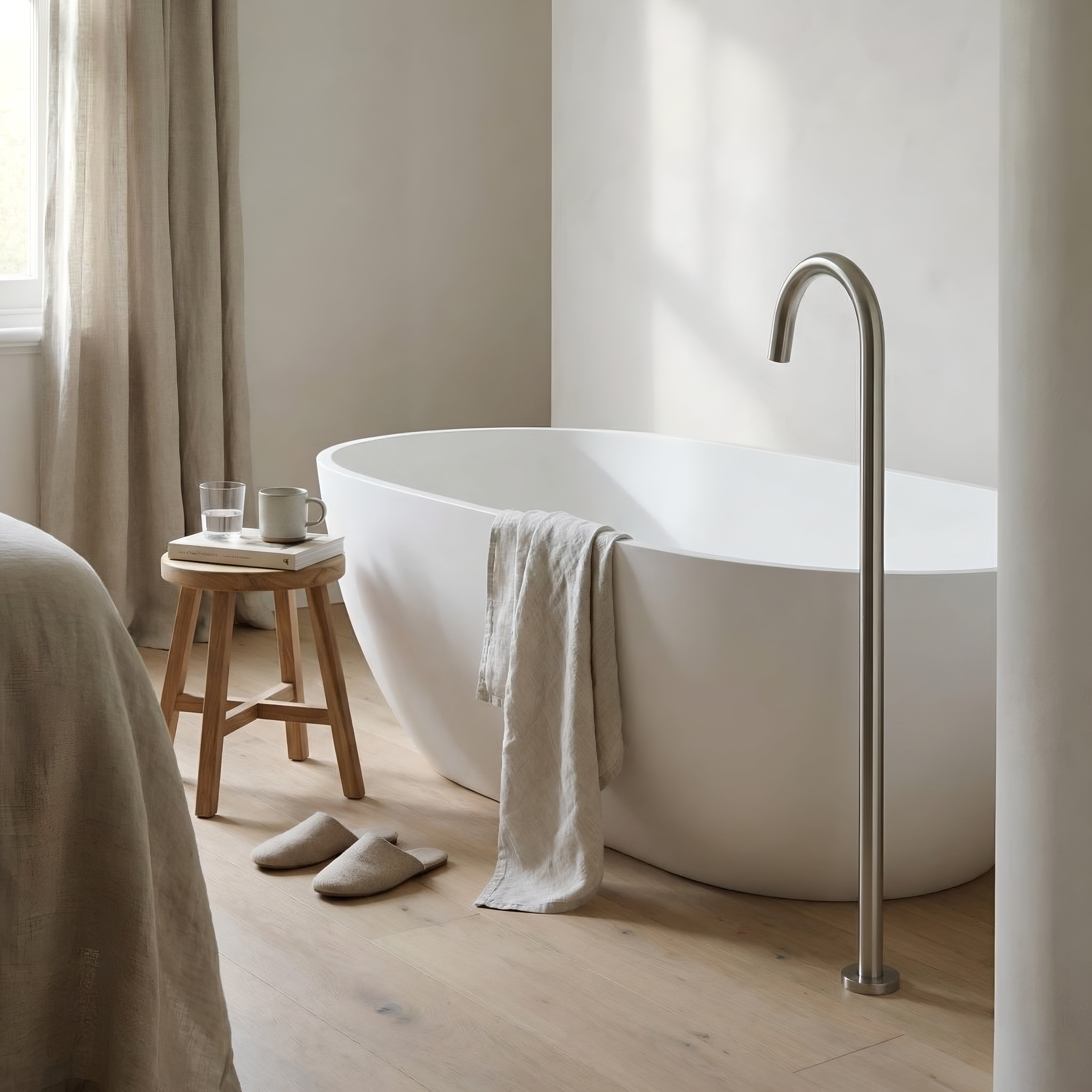 Modern bathroom with a freestanding bathtub and brushed nickel floor spout.