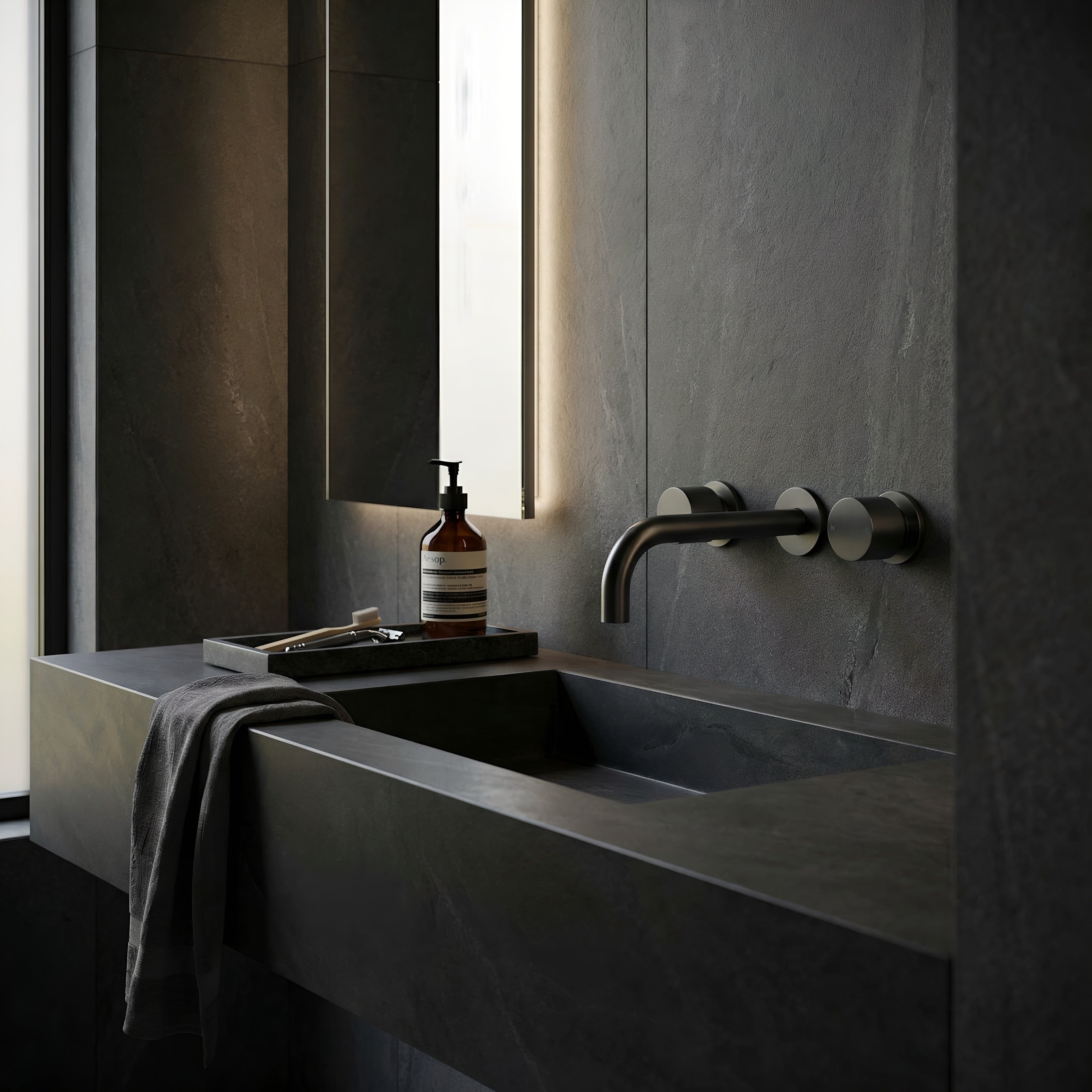 Modern bathroom sink with round wall taps in gun metal, minimalistic design