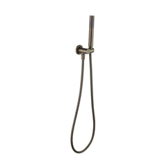 an antique brass shower handpiece mounted on a bracket, with a hose attached to it on a white background