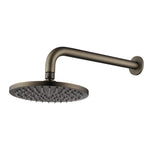 antique brass round shower head on wall with a white background