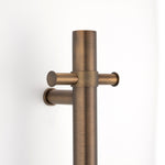 antique brass close up single upright bar heated towel rail on a white background