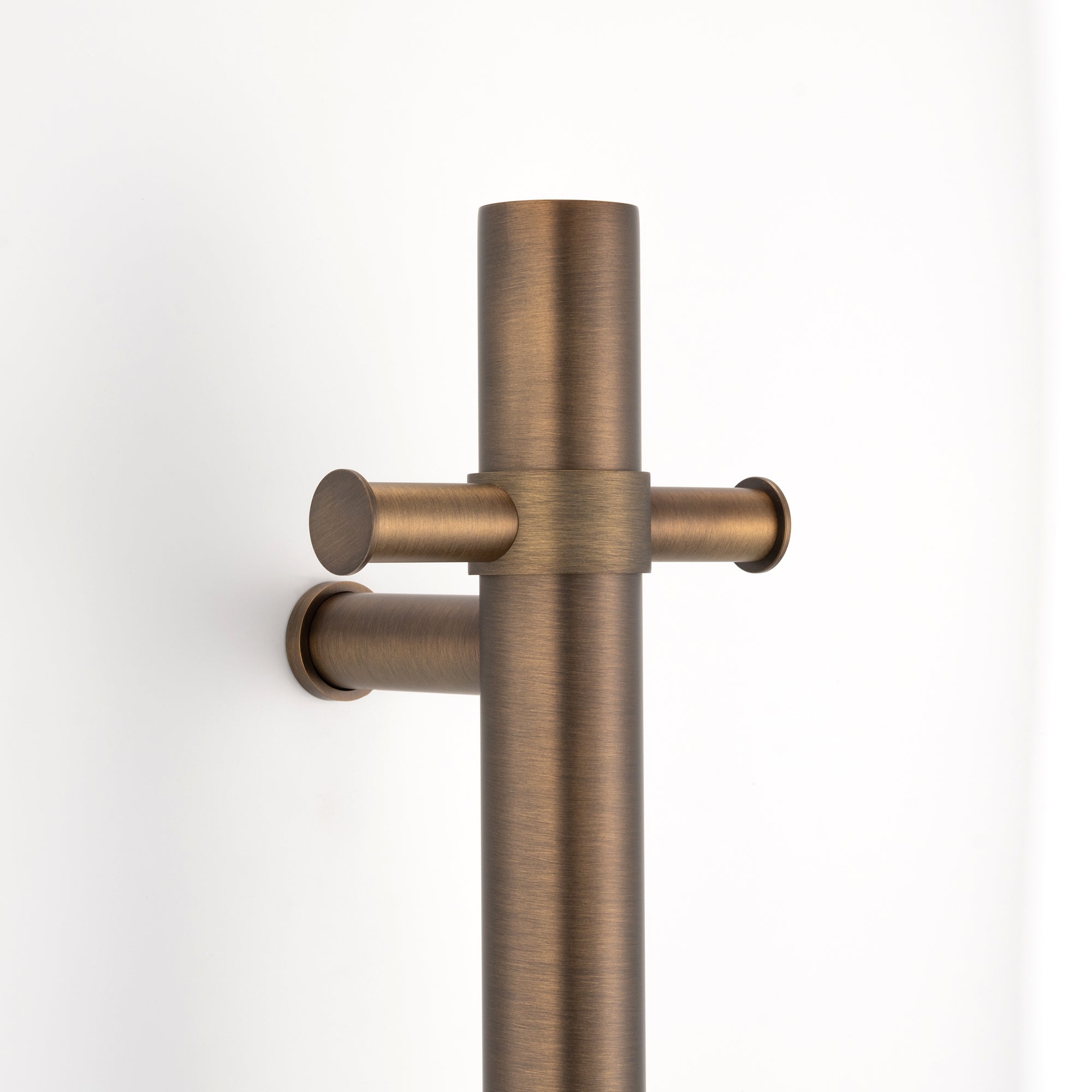 antique brass close up single upright bar heated towel rail on a white background