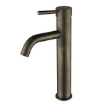 antique brass tall basin mixer tap on a white background