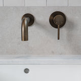 antique brass wall mounted over vanity wall mixer and spout on grey and white tile background