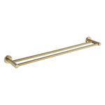 A brushed gold double towel rail wall mounted set against a white background
