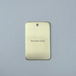 Brushed gold sample disc on a white background
