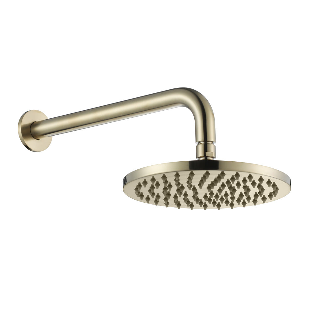 brushed gold round shower head on wall with a white background
