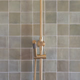 brushed gold twin round combination shower rail with diverter on a green feature tile background