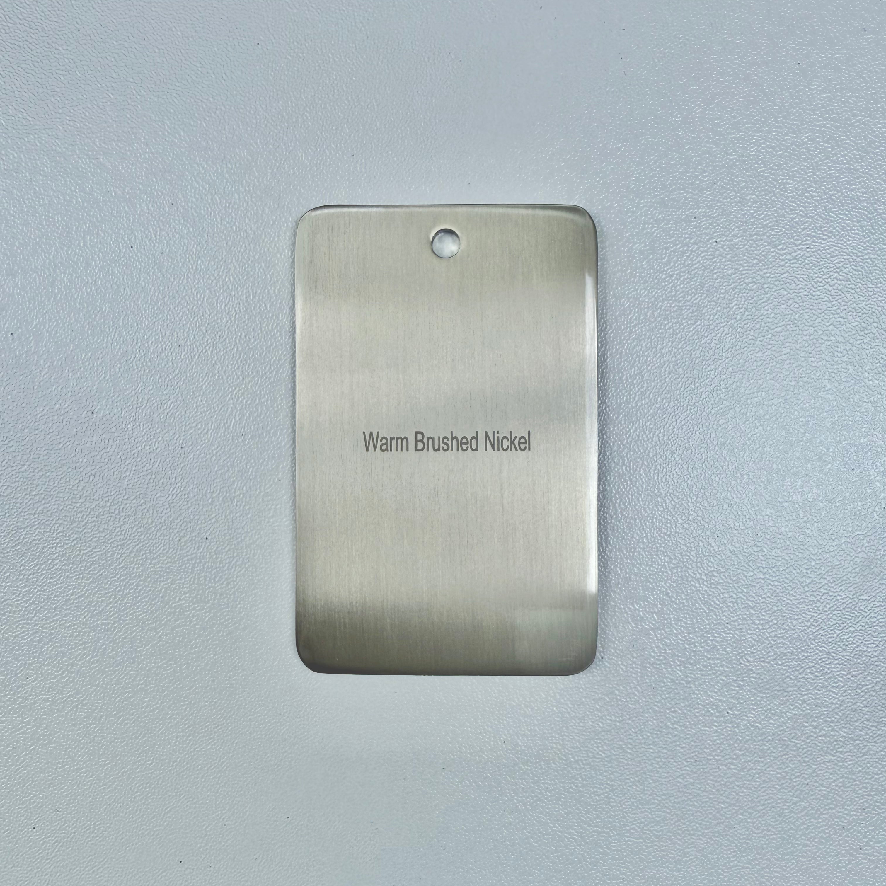 brushed nickel sample disc on a grey background