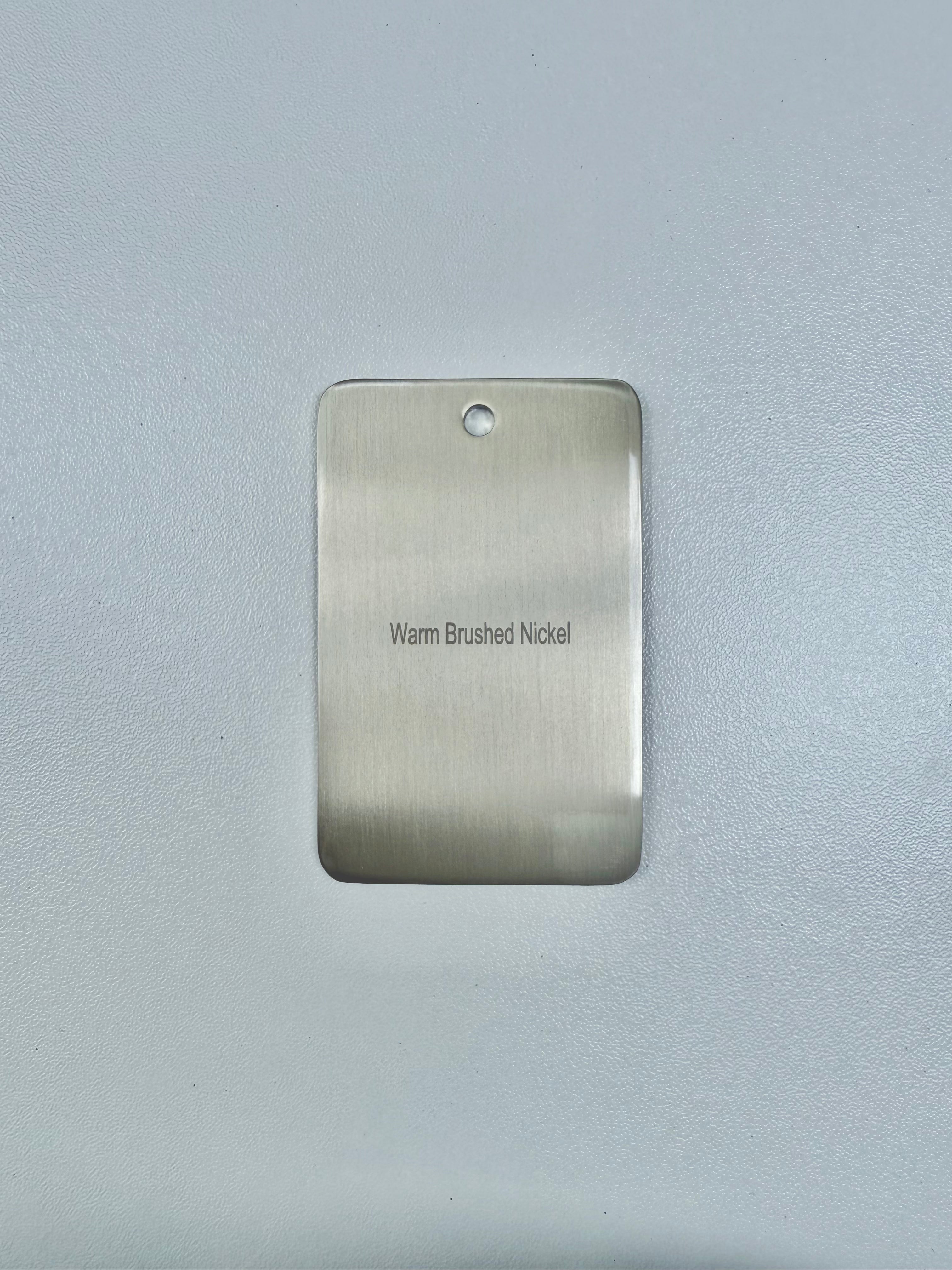 brushed nickel sample disc on a grey background
