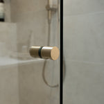 Brushed nickel shower door handle on a shower glass door