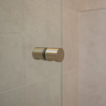 Brushed nickel shower door handle on a shower glass door