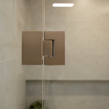 Brushed nickel shower glass hinge with glass shower  and tiled wall.