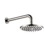 brushed nickel round shower head on wall with a white background