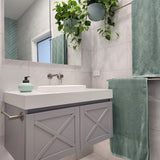 a brushed nickel towel holder mounted on a grey vanity with white stone top