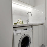 Modern laundry with white cabinets, white splashback and chrome pull-out kitchen/laundry mixer