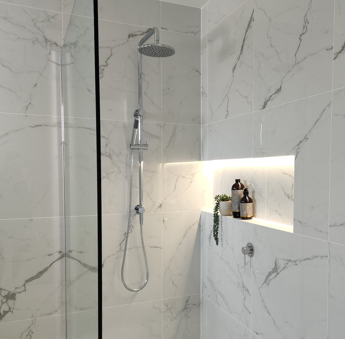 a chrome twin function shower with a handheld wand on a marble tile background