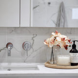  chrome wall spout and mixer on a marble tile background