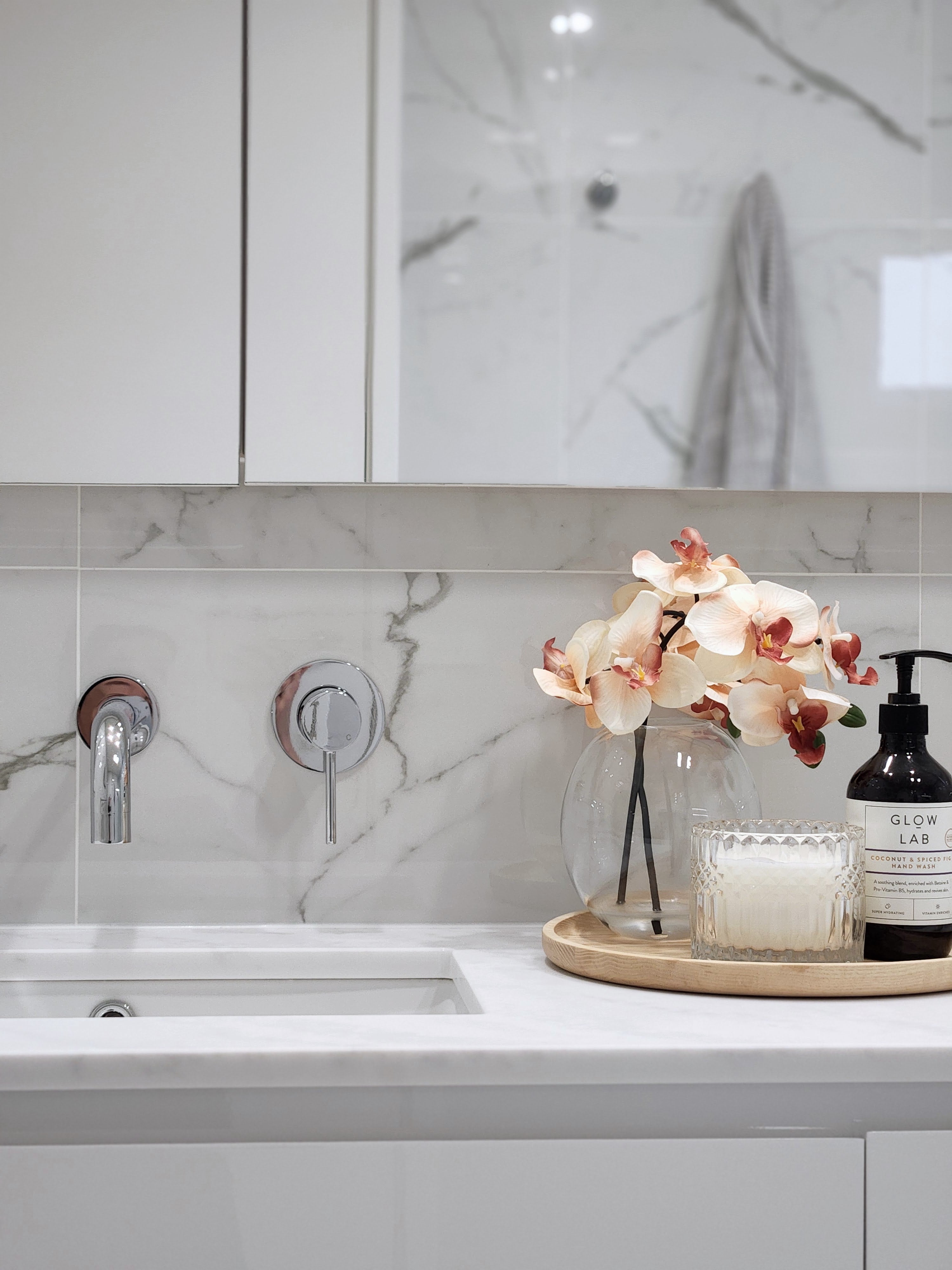  chrome wall spout and mixer on a marble tile background