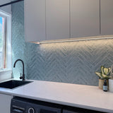 Modern Laundry with white cabinets, a chevron-patterned backsplash, and with a gun metal kitchen/laundry mixer