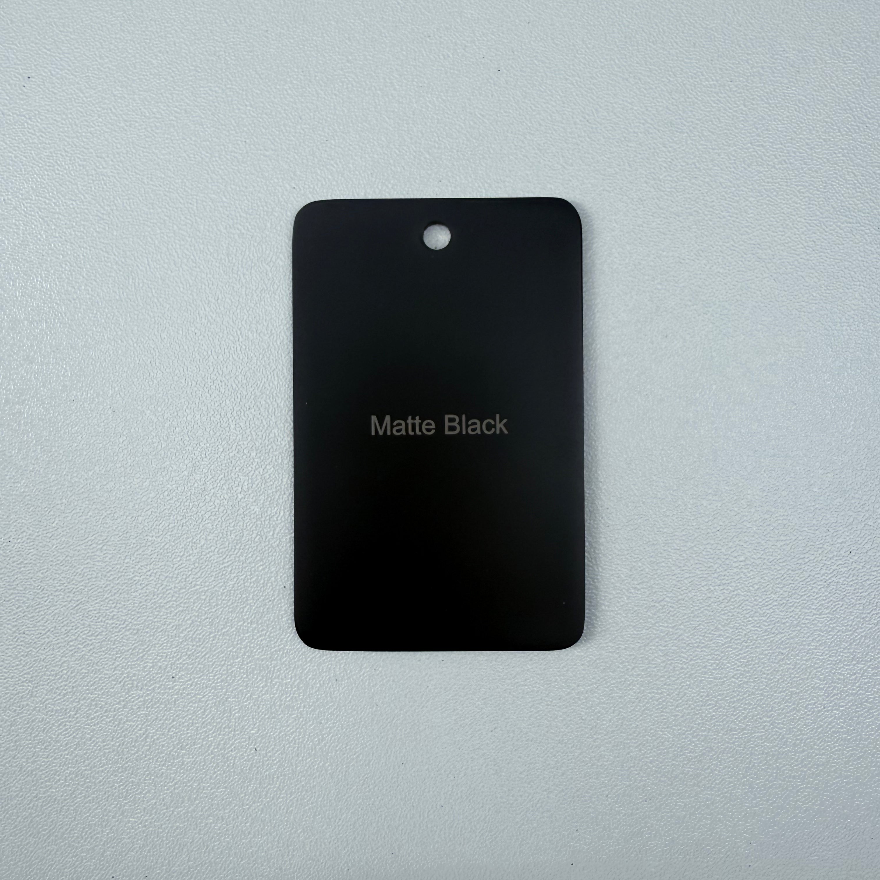Matt Black sample disc on a grey background