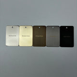 Five metal color samples labeled 'Warm Brushed Nickel', 'Brushed Gold', 'Antique Brass', 'Gun Metal', and 'Matt Black' on a grey background. 